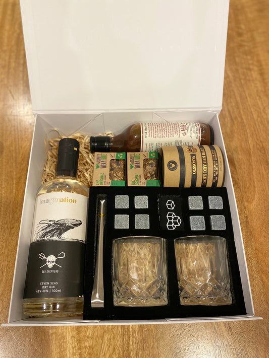 Imagination seven seas gin, Glass eye creek wild meat sauce, x2 crafty weka mini bites, Olssons gin salt rub, 2x glass tumblers, ice tongs, 8 stone rocks. all packaged in a beautiful magnetic box with ribbons and personalized message.gratefully gifted Christchurch new zealand 