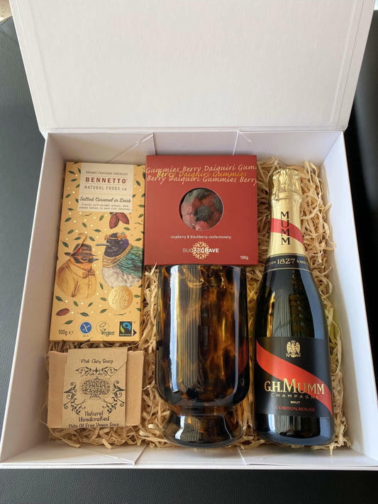 raspberry daiquiri gummies, Bennetto salted caramel chocolate block, mumm 750ml champagne, handblown glass tortishell vase. panna pink clay vegan soap. all packaged in a beautiful magnetic box with ribbons and personalized message.gratefully gifted Christchurch new zealand 